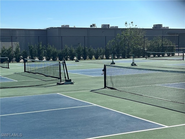 view of sport court featuring fence