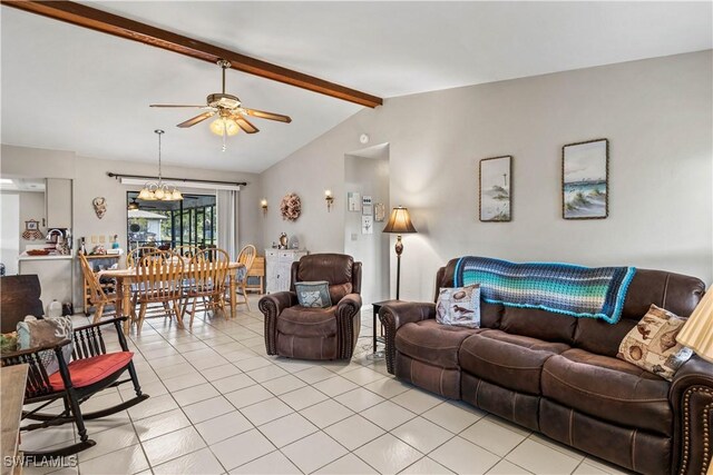 tiled living room featuring lofted ceiling with beams and ceiling fan with notable chandelier