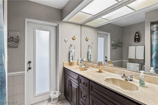 bathroom with vanity, toilet, and tile patterned flooring