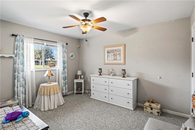 interior space with baseboards, a ceiling fan, and light colored carpet