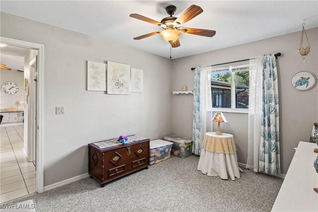 rec room featuring ceiling fan and light colored carpet