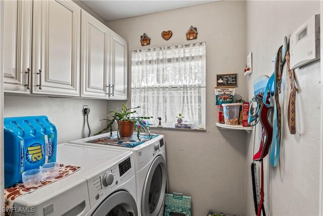 laundry room with cabinets and independent washer and dryer