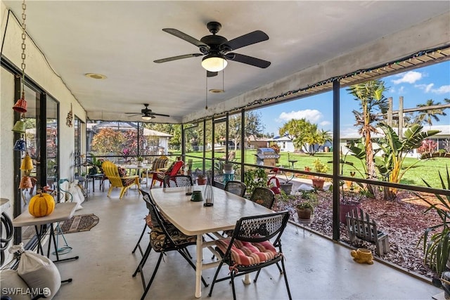 sunroom with a ceiling fan