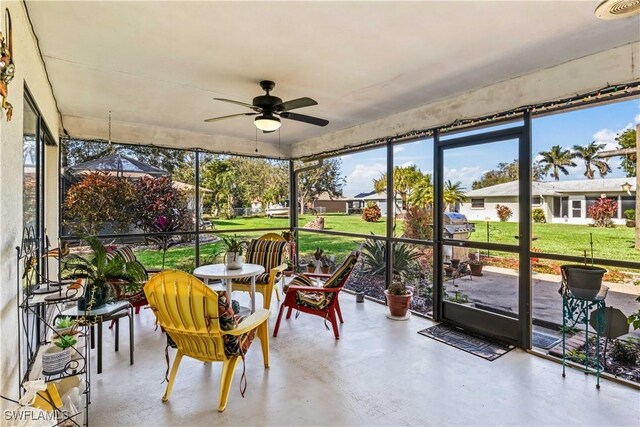 sunroom / solarium featuring ceiling fan