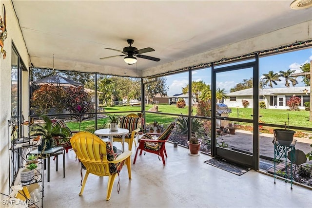 sunroom featuring ceiling fan