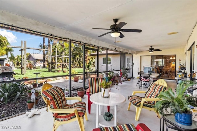 sunroom featuring a ceiling fan