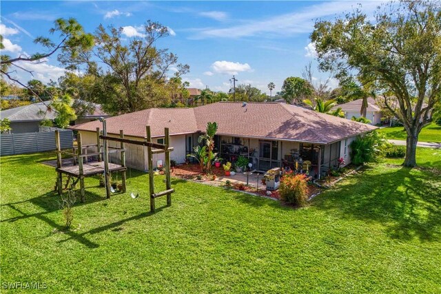 back of house with a patio and a lawn