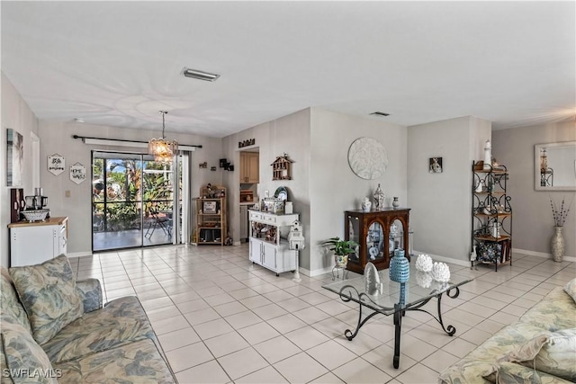 tiled living room featuring a chandelier