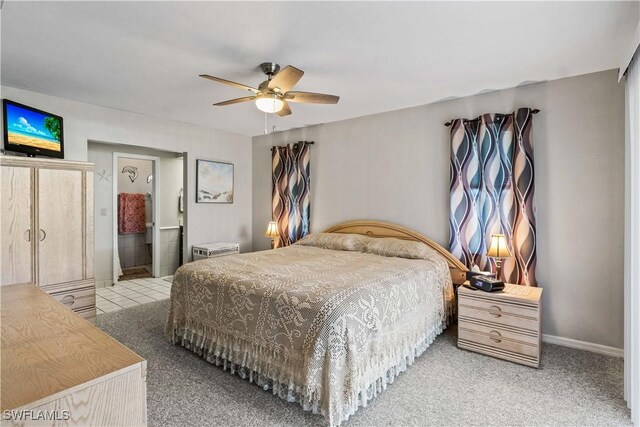 carpeted bedroom featuring ensuite bathroom and ceiling fan