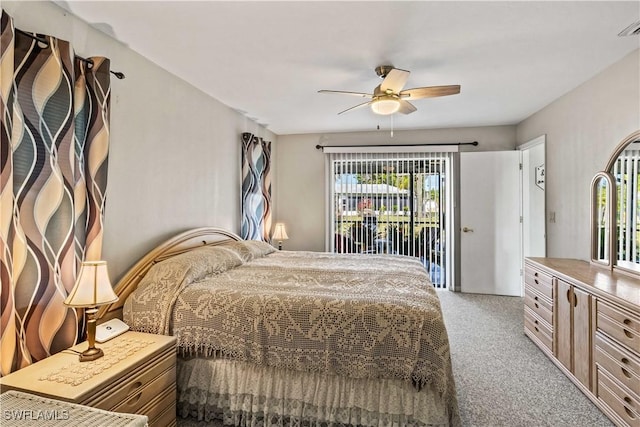 bedroom featuring ceiling fan, visible vents, light colored carpet, and access to exterior