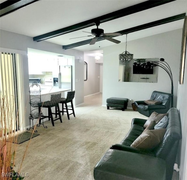 carpeted living room featuring ceiling fan, lofted ceiling with beams, and baseboards