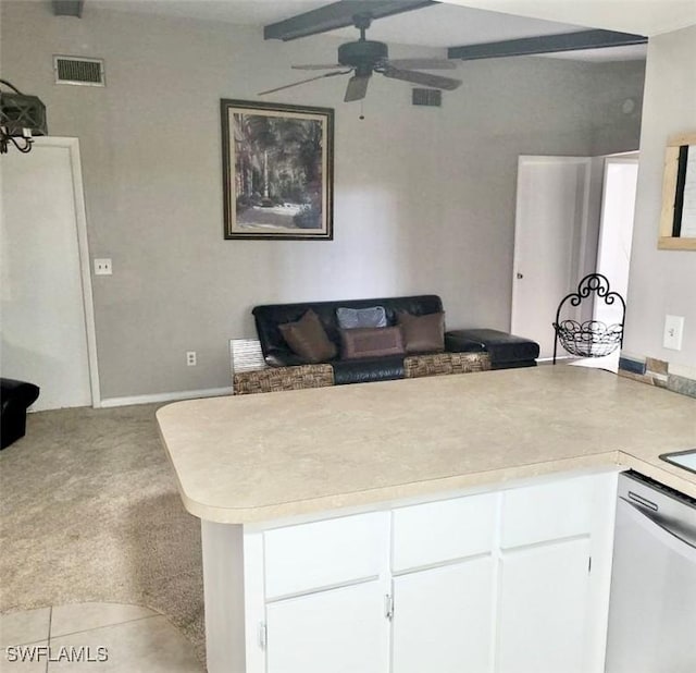 kitchen featuring dishwasher, a peninsula, light carpet, and visible vents