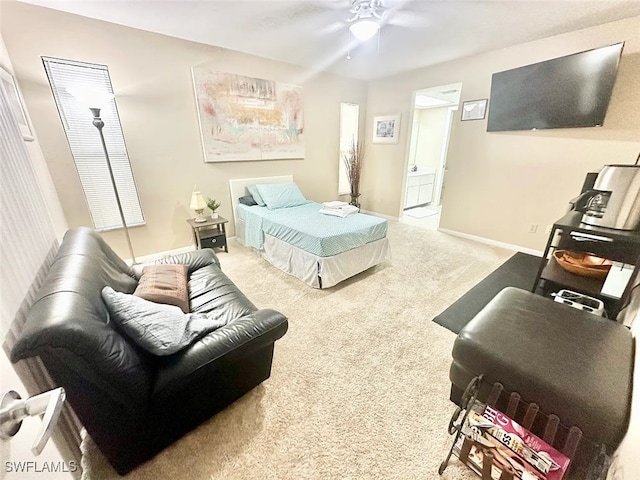 carpeted bedroom with a ceiling fan, baseboards, and connected bathroom