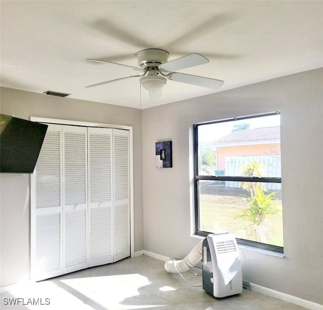 bedroom with baseboards, visible vents, ceiling fan, and a closet