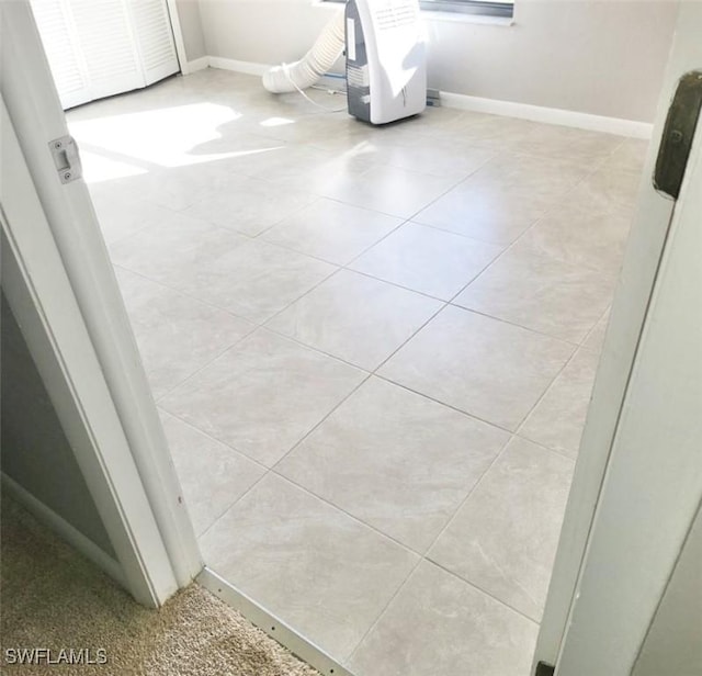 bathroom with tile patterned flooring and baseboards