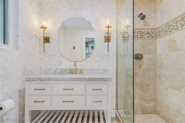 bathroom with vanity and a tile shower