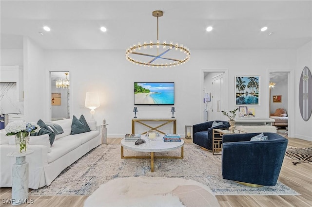 living room with a notable chandelier and light wood-type flooring