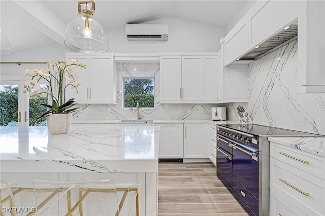 kitchen with white cabinetry, decorative backsplash, range with two ovens, hanging light fixtures, and a wall unit AC