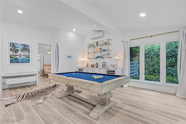 playroom featuring bar, a wall mounted AC, light wood-type flooring, and billiards