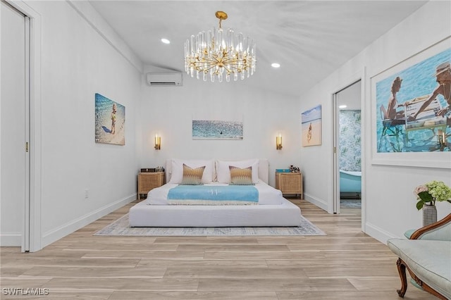 bedroom featuring an inviting chandelier, a wall mounted AC, and light hardwood / wood-style flooring