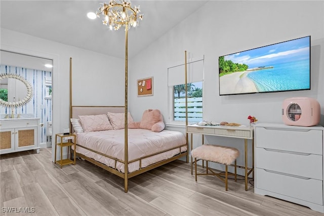 bedroom featuring a notable chandelier, vaulted ceiling, and light wood-type flooring