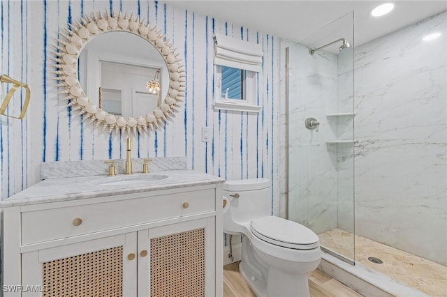 bathroom featuring walk in shower, wood-type flooring, vanity, and toilet