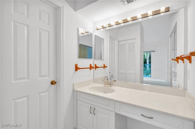 bathroom featuring vanity and a textured ceiling