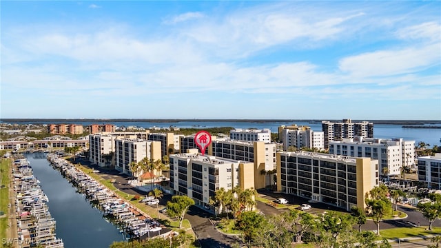 birds eye view of property featuring a water view and a city view