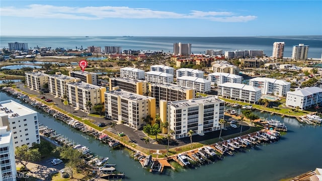 birds eye view of property featuring a water view and a city view