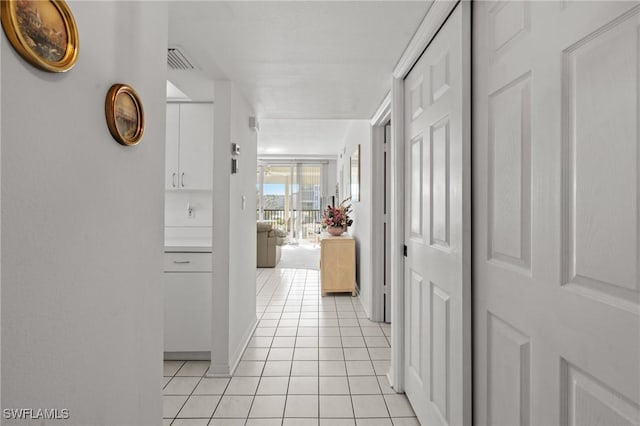 hall with light tile patterned floors and visible vents