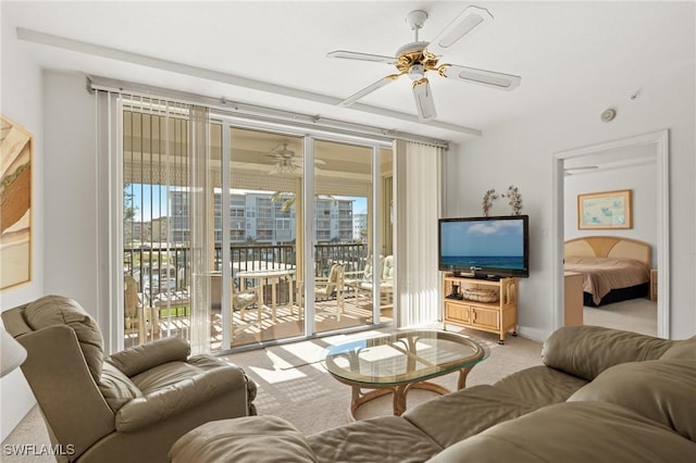 carpeted living area with a healthy amount of sunlight and a ceiling fan