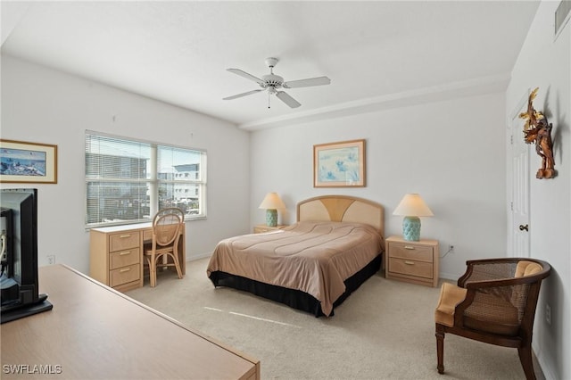 bedroom featuring a ceiling fan, visible vents, and light colored carpet