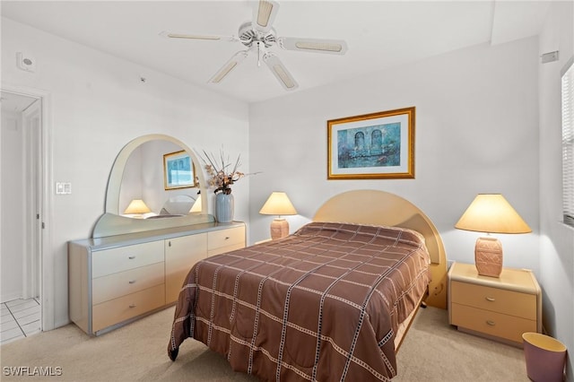 bedroom featuring light carpet and a ceiling fan