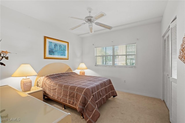 carpeted bedroom with a ceiling fan and baseboards