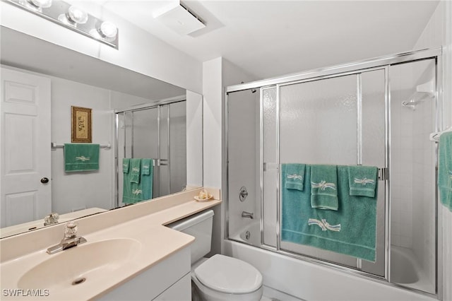 full bath featuring bath / shower combo with glass door, vanity, and toilet