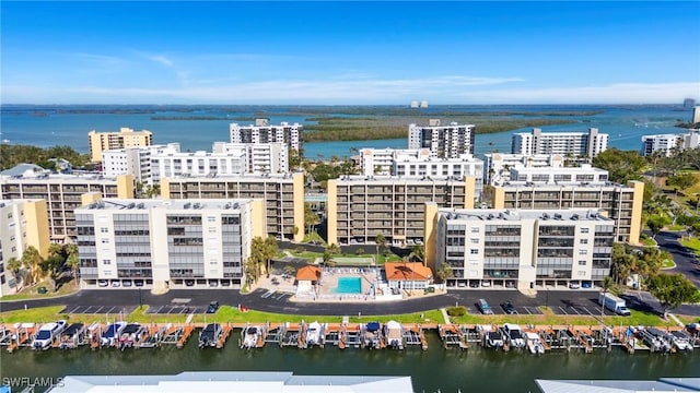 birds eye view of property featuring a water view and a city view