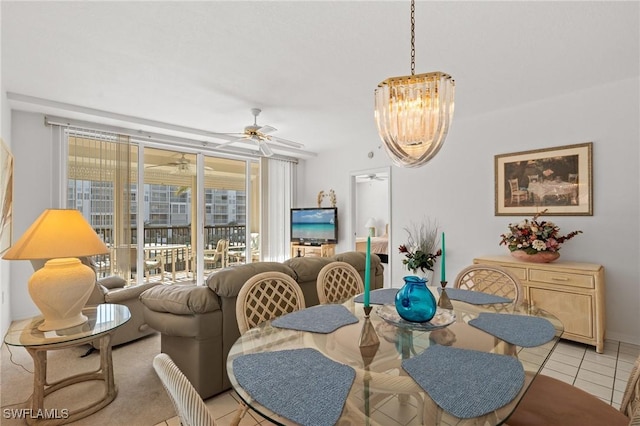 dining area featuring light tile patterned floors and ceiling fan with notable chandelier