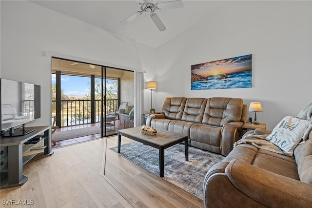 living room with ceiling fan, high vaulted ceiling, and hardwood / wood-style floors