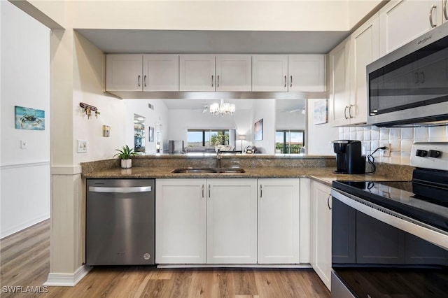 kitchen with white cabinetry and appliances with stainless steel finishes