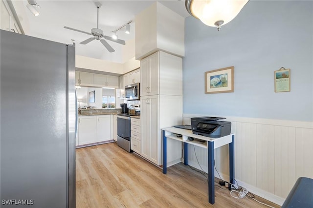 kitchen with ceiling fan, light hardwood / wood-style floors, white cabinets, and appliances with stainless steel finishes