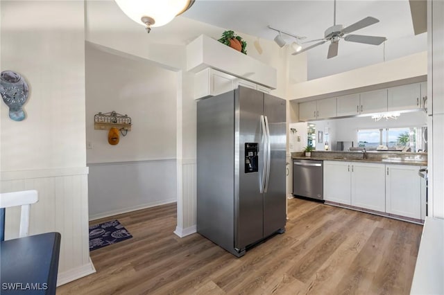 kitchen featuring white cabinetry, appliances with stainless steel finishes, sink, and light wood-type flooring