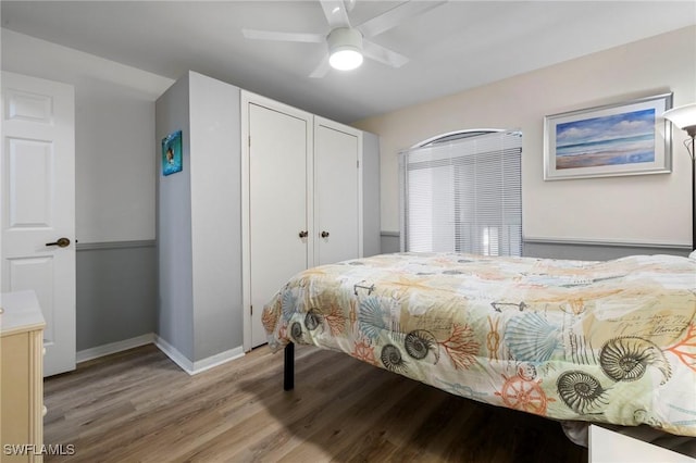 bedroom with ceiling fan, light hardwood / wood-style floors, and a closet