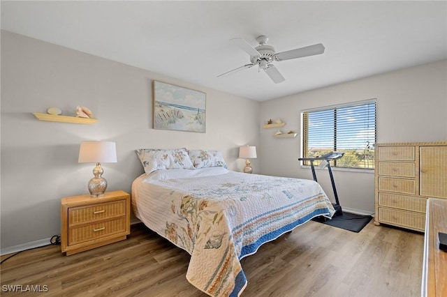 bedroom with dark wood-type flooring and ceiling fan