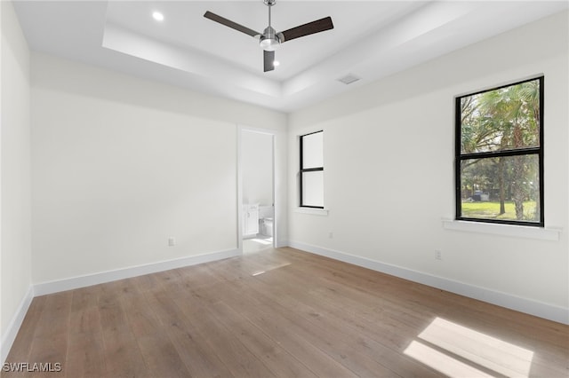 740 13th St NW, Naples, FL 34120 - empty room with a tray ceiling, light wood-style floors, ceiling fan, and recessed lighting