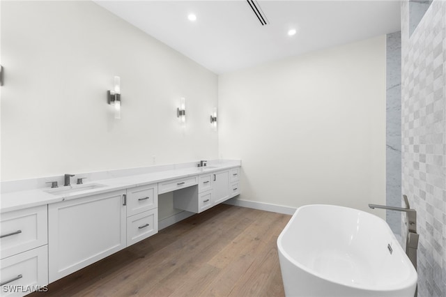 bathroom featuring vanity, a tub, and hardwood / wood-style floors