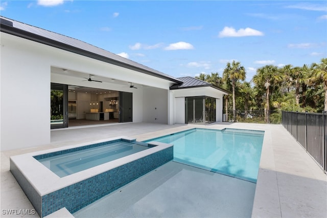 view of pool with a patio, ceiling fan, and an in ground hot tub