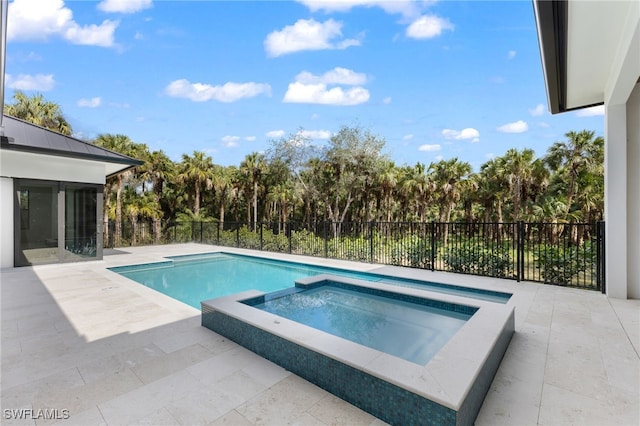 740 13th St NW, Naples, FL 34120 - view of swimming pool with a patio area, a pool with connected hot tub, a sunroom, and view of wooded area