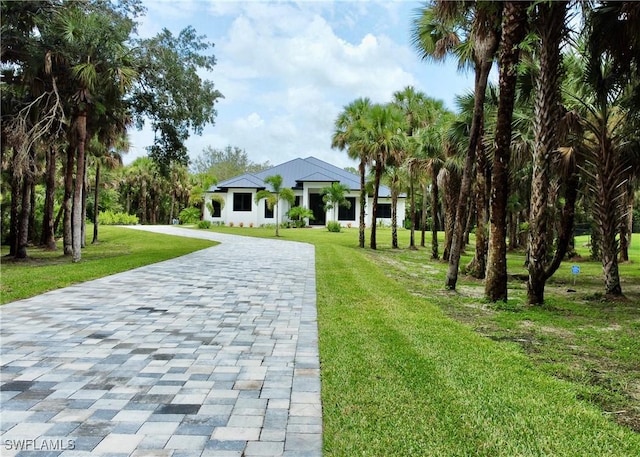 740 13th St NW, Naples, FL 34120 - view of community featuring decorative driveway and a lawn