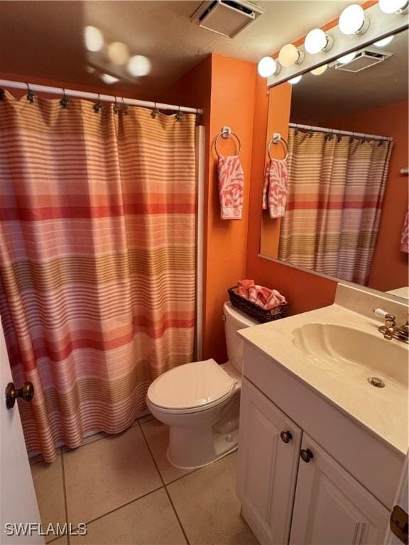 bathroom with walk in shower, vanity, toilet, and tile patterned flooring