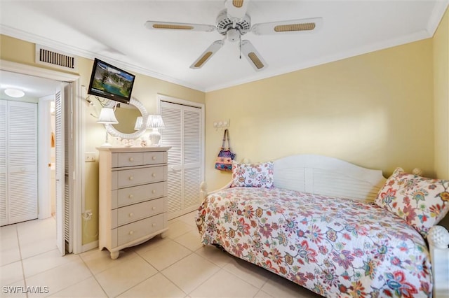 tiled bedroom featuring ornamental molding, a closet, and ceiling fan